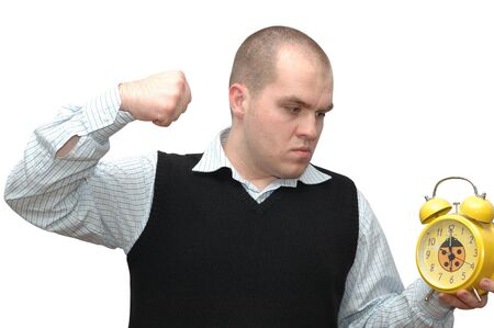 Conceptual photo of young man trying to destroy alarm clockの写真素材
