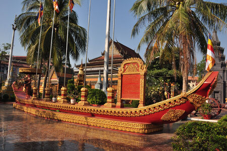 A statue of a monk in a canoe in the gardens of Preah Promreath Pagoda in Siem Reap, Cambodiaのeditorial素材