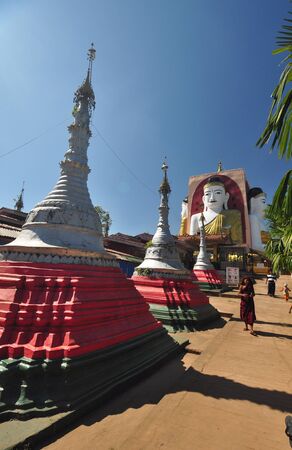 Bago,Myanmar - 29 November 2015: Unknown monk visits Kyaik Pun Pagoda, Pagoda of four giant Buddha statues in Bago, Myanmar.のeditorial素材