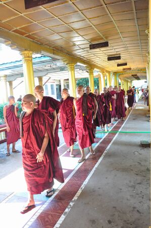 Yangon,Myanmar - 28 November 2015: Unknown monks walking at the temple of Shwethalyaung Reclining Buddha in Bago, Myanmar. It is the most famous reclining buddha in Bago, Myanmar.のeditorial素材