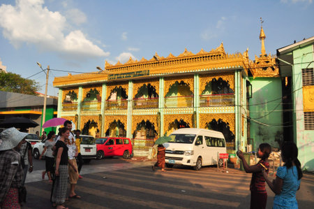 Yangon,Myanmar - 29 November 2015: Burmese women taking picture for foreigners at  the temple of Botataung Pagoda.Botataung Pagoda is a famous pagoda located in Yangon, Myanmar.のeditorial素材