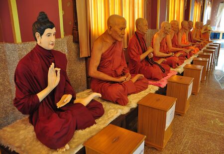 Row of famous monk buddhist statues in thai temple, angthong, Thailandのeditorial素材