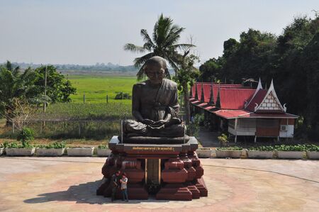 Ang Thong,Thailand- December 10,2016:  Unidentified tourists visit Wat Khun Inthapramun, Ang Thong Province, Thailand.The statue is Phra Buddhacharn Toh Phomarangsi, famous monk in  Thailand.のeditorial素材