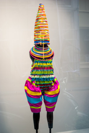 Mannequin wearing colorful clothes in the shop window of a fashion storeの写真素材