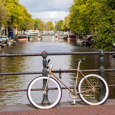 Bicycle on the embankment of the canal in Amsterdam, Netherlandsの写真素材