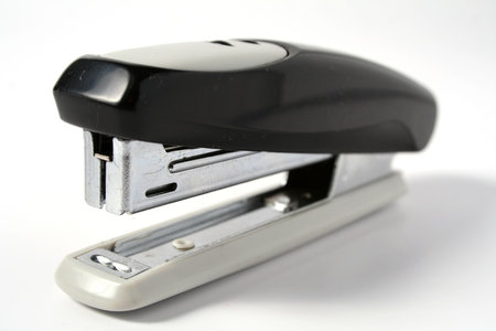 Necessary office accessory - a metal stapler with the plastic handle