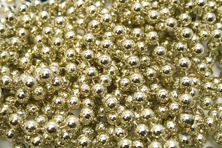Background made of a brilliant celebratory beads of golden colorの写真素材