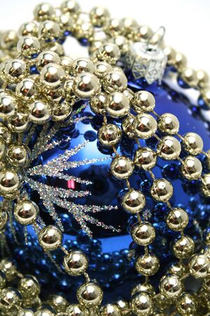 Blue glass sphere and celebratory beads on a white backgroundの写真素材