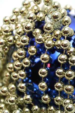 Dark blue glass sphere with a pattern and a celebratory beads of golden colorの写真素材