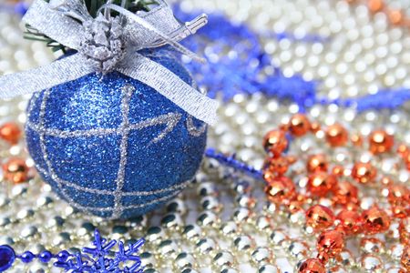 Christmas sphere of dark blue color with a pattern on a background of a multi-coloured beads の写真素材