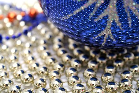 Dark blue christmas sphere on a background of a brilliant celebratory beads の写真素材