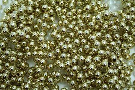 Celebratory brilliant beads of golden and white color horizontallyの写真素材
