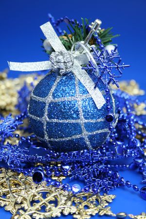 Christmas sphere of dark blue color with a pattern and a celebratory beads の写真素材
