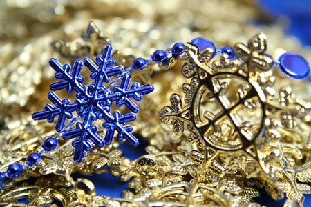 Christmas garlands of dark blue and yellow color in the form of snowflakesの写真素材