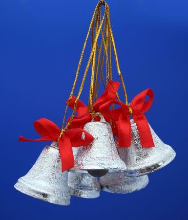 Christmas celebratory handbells of silvery color on a dark blue background の写真素材