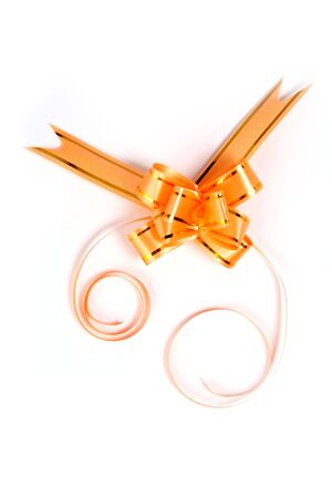 Gift bow of yellow color on a white background の写真素材