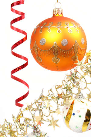 Yellow New Year's sphere on a background of a tinsel and asterisks の写真素材