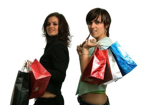 The happy girls with purchases, on a white background の写真素材