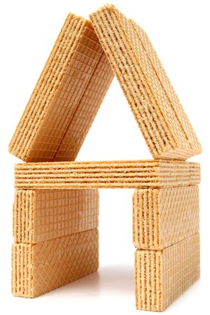 Toy small house made of wafers with a vanilla cream macroの写真素材