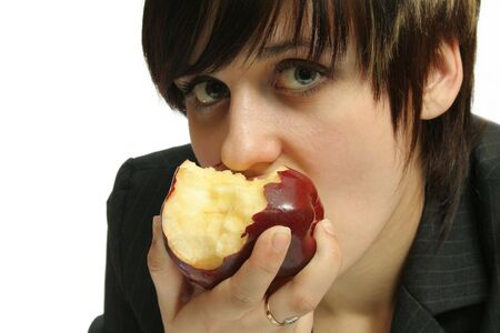 The young nice girl with a red apple, isolated on whiteの写真素材