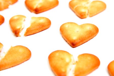 Salty cookies in the form of the broken hearts 2, isolated on whiteの写真素材