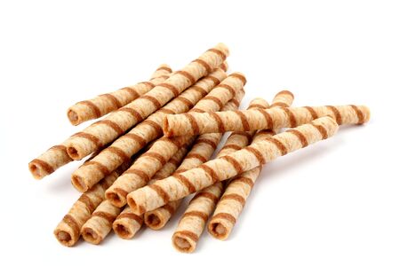 Heap of striped wafer tubules with the chocolate cream, isolated, (look similar images in my portfolio)の写真素材