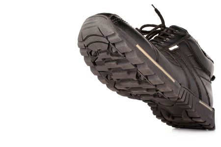 Left man's winter leather a boot of darkly brown color, the bottom view, isolated on white, (look similar images in my portfolio)の写真素材