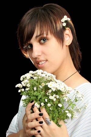 The young beautiful girl with flowers, isolated on a black backgroundの写真素材
