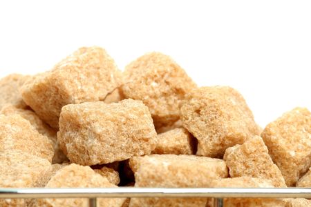 Stack of not refined brown reed sugar, on whiteの写真素材