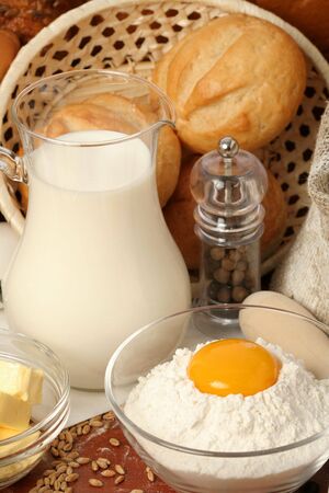 Jug of milk, butter and flour with yolkè の写真素材