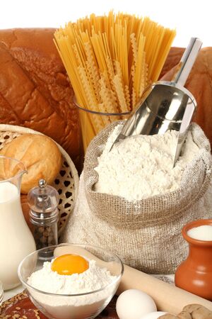Jug of milk, sugar and flour with yolk, isolated on whiteの写真素材