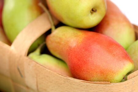 Ripe fresh pears in a basket, backgroundの写真素材
