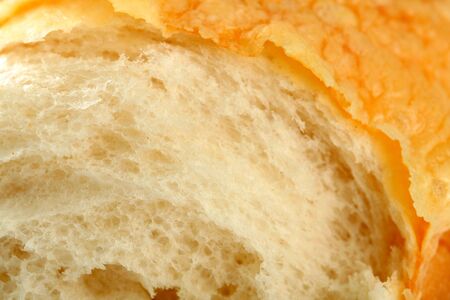 Slice of fresh bread with a cheese crust, backgroundの写真素材