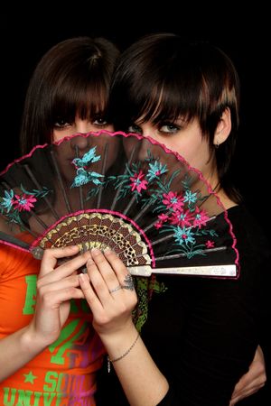 Girls with a spanish fan, on black backgroundの写真素材