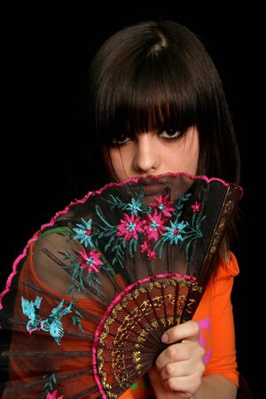 Girl with a spanish fan, on black backgroundの写真素材