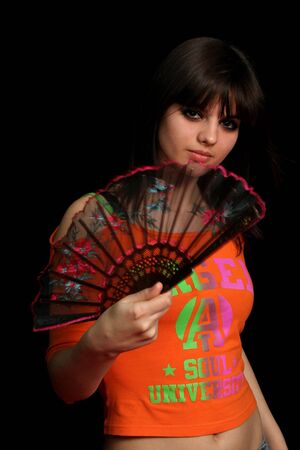Girl with a spanish fan, on black backgroundの写真素材