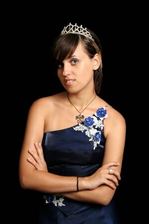 Girl in an blue evening dress and with a diadem, isolated on blackの写真素材