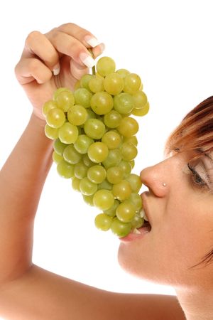 Girl with a cluster of green grapes, isolated on whiteの写真素材
