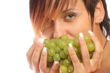 Girl with a cluster of green grapes, isolated on whiteの写真素材