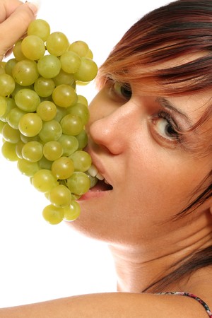 beautiful girl with green grape on whiteの写真素材
