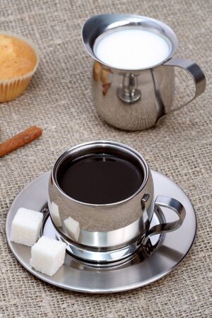 Cup of black coffee with muffin, milk and cinnamon, coffee seriesの写真素材