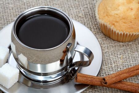 Cup of black coffee with muffin and cinnamon, coffee seriesの写真素材