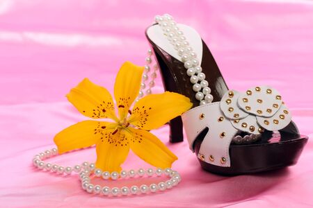 Woman shoes on pink satinの写真素材