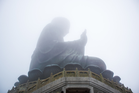 The enormous Tian Tan Buddha statue in the cloud at high mountain near Po Lin Monastery, Lantau Island, Hong Kong.のeditorial素材