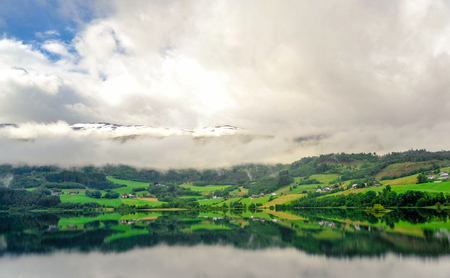 Beautiful landscape and scenery view of Norway, green scenery of hills and mountain in a cloudy dayの写真素材