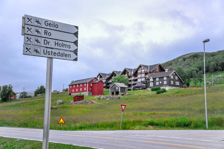 GEILO, NORWAY - JULY, 2015: A typical street sign with hotel in background in small city of Geilo, Norwayのeditorial素材