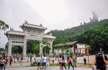 HONG KONG: Gate to the Po Lin Monastery with Tian Tan Buddha statue up on the hill in Ngong Ping Village, Lantau Island, Hong Kongのeditorial素材