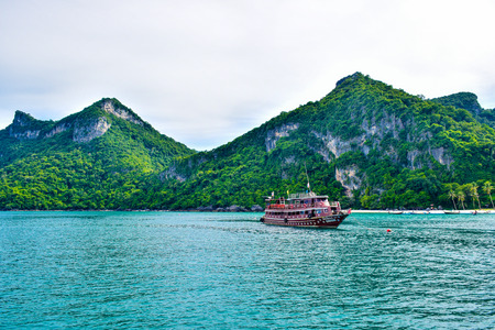 A boat taking tourists for sightseeing at Ang Thong Island National Marine Park near Samui island, one of the most famous tourist vacation destinationのeditorial素材