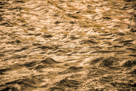 Golden water surface with soft waves abstract background