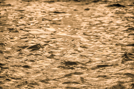 Golden water surface with soft waves abstract backgroundの写真素材